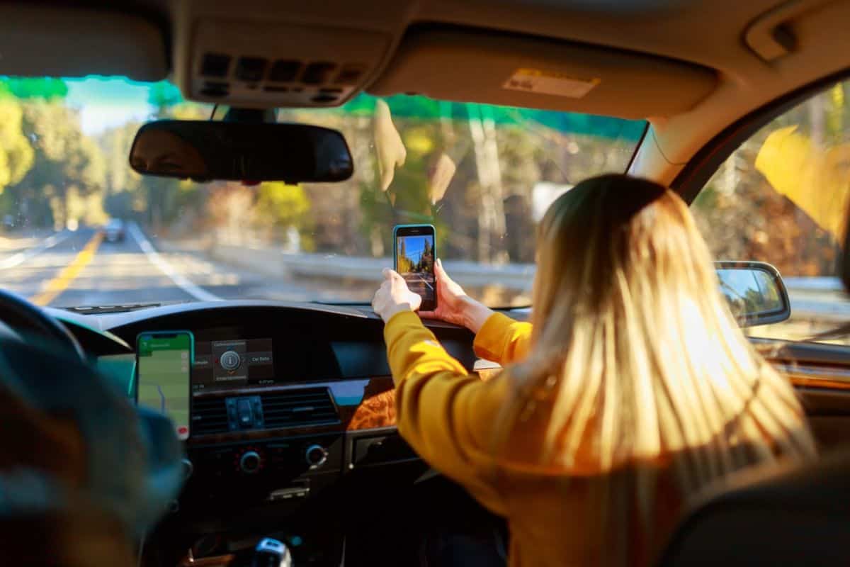 woman taking picture while driving